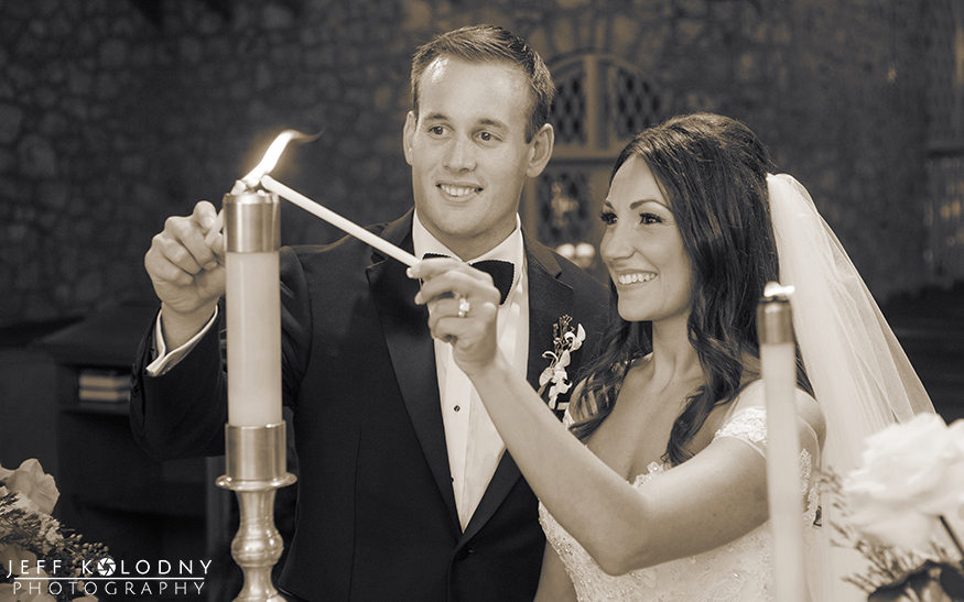 Bride and groom lighting the unity candle at the Plymouth Congregational church in Coral Gables 