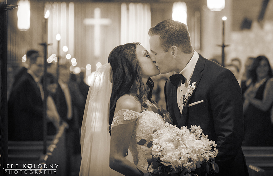 Bride and Groom kiss at the Plymouth Congregational church.